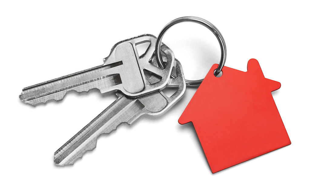 Set of Keys With Red House Isolated on White Background.